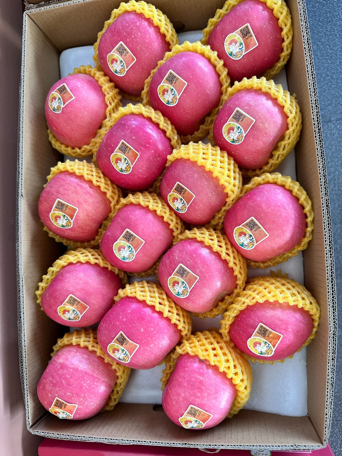 Actual cartons of pink apples with product labels supplied by 3YY Fresh